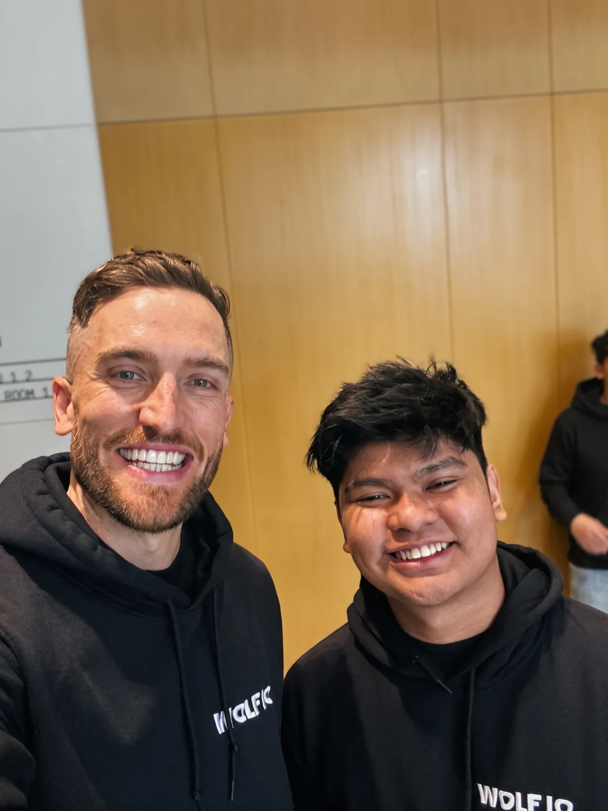 Andy Crebar and Mercelo in Wolf IQ hoodies, grinning in a phone selfie