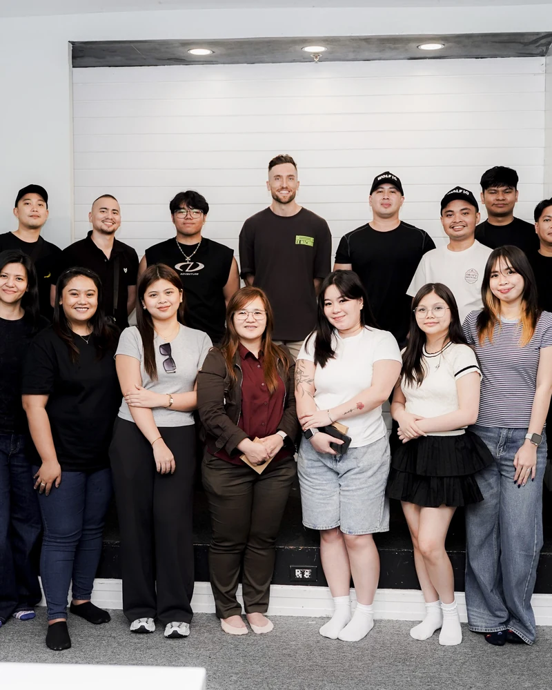 The full Wolf IQ team lined up for a group photo in front of a whiteboard
